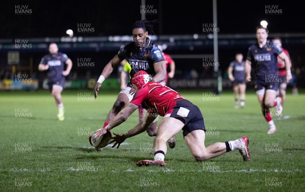 280226 - Ospreys v Ulster Rugby, United Rugby Championship - Dan Kasende of Ospreys robs Michael Lowry of Ulster of the ball and touches down to score try
