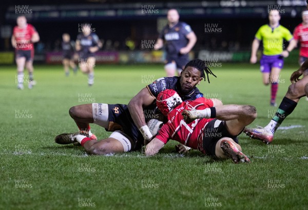 280226 - Ospreys v Ulster Rugby, United Rugby Championship - Dan Kasende of Ospreys robs Michael Lowry of Ulster of the ball and touches down to score try