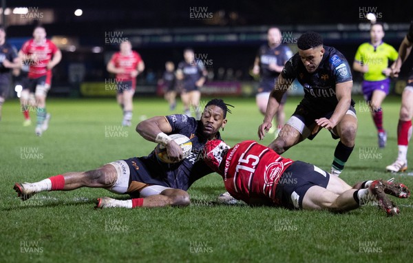 280226 - Ospreys v Ulster Rugby, United Rugby Championship - Dan Kasende of Ospreys robs Michael Lowry of Ulster of the ball and touches down to score try