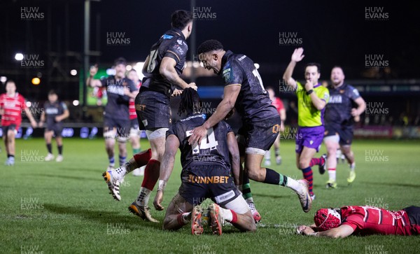 280226 - Ospreys v Ulster Rugby, United Rugby Championship - Dan Kasende of Ospreys robs Michael Lowry of Ulster of the ball and touches down to score try