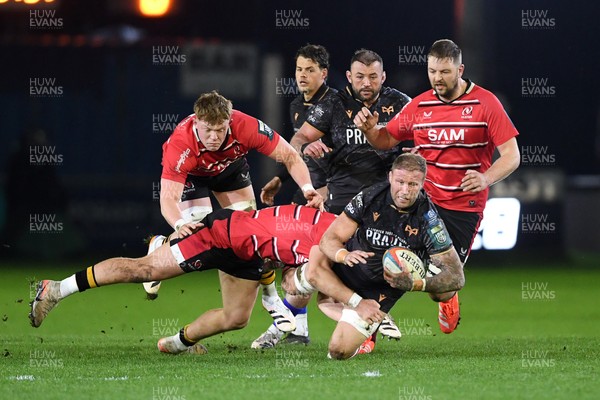 280226 - Ospreys v Ulster - United Rugby Championship - Ross Moriarty of Ospreys is challenged by Tom Stewart of Ulster