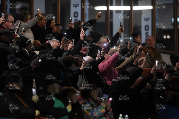 280226 - Ospreys v Ulster - United Rugby Championship - Fans shine their phone lights in protest in the 11th minute after the recent decision made regarding Ospreys by the WRU