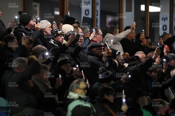 280226 - Ospreys v Ulster - United Rugby Championship - Fans shine their phone lights in protest in the 11th minute after the recent decision made regarding Ospreys by the WRU