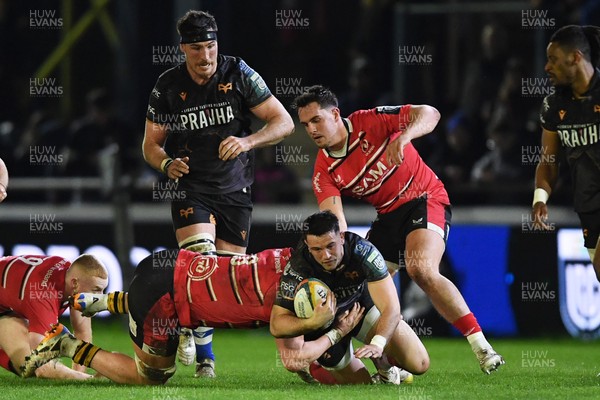 280226 - Ospreys v Ulster - United Rugby Championship - Owen Watkin of Ospreys is challenged by Bryn Ward of Ulster