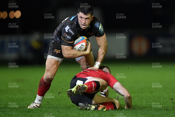 280226 - Ospreys v Ulster - United Rugby Championship - Owen Watkin of Ospreys is challenged by Nathan Doak of Ulster