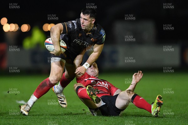 280226 - Ospreys v Ulster - United Rugby Championship - Owen Watkin of Ospreys is challenged by Nathan Doak of Ulster