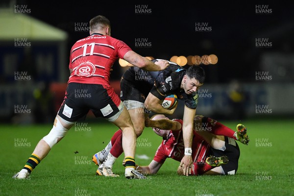 280226 - Ospreys v Ulster - United Rugby Championship - Owen Watkin of Ospreys is challenged by Zac Ward of Ulster