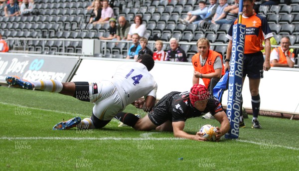 240813 - Ospreys v Worcester Warriors, Pre-season Friendly - Ospreys Richard Fussell beats Worcester's Josh Drauniniu to score try