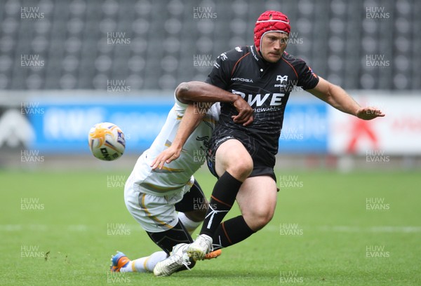 240813 - Ospreys v Worcester Warriors, Pre-season Friendly - Ospreys Richard Fussell is tackled by Worcester's Josh Drauniniu