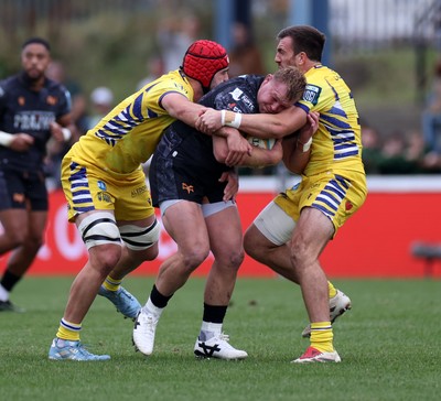 111025 - Ospreys v Zebre Parma - United Rugby Championship - Dewi Lake of Ospreys is tackled by Matteo Canali of Zebre and Enrico Lucchin of Zebre Parma 