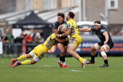111025 - Ospreys v Zebre Parma - United Rugby Championship - Jack Walsh of Ospreys is tackled by Simone Gesi and Marco Zanon of Zebre Parma 
