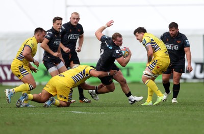 111025 - Ospreys v Zebre Parma - United Rugby Championship - Dewi Lake of Ospreys is tackled by Paolo Buonfiglio of Zebre Parma 