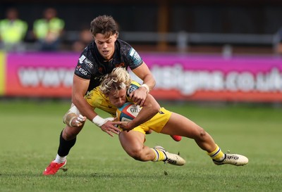 111025 - Ospreys v Zebre Parma - United Rugby Championship - Thomas Dominguez of Zebre Parma is tackled by Jack Walsh of Ospreys 