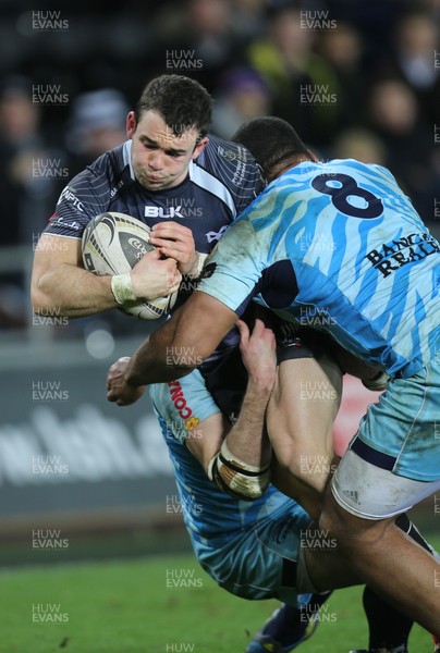 280315 - Ospreys v Zebre Rugby, Guinness PRO12 - Ospreys Tom Habberfield is tackled by Zebre's Samuela Vunisa and Zebre's Filippo Cristiano