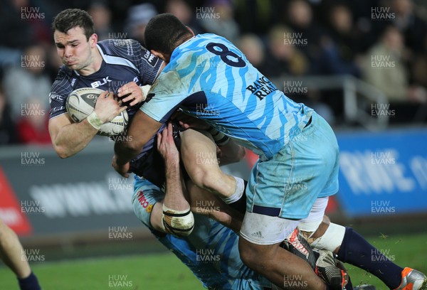 280315 - Ospreys v Zebre Rugby, Guinness PRO12 - Ospreys Tom Habberfield is tackled by Zebre's Samuela Vunisa and Zebre's Filippo Cristiano