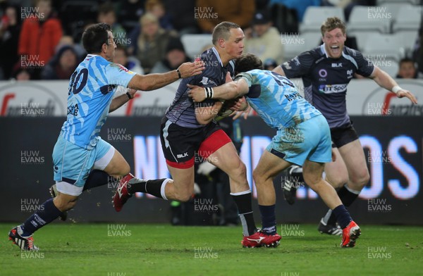 280315 - Ospreys v Zebre Rugby, Guinness PRO12 - Ospreys Hanno Dirksen is tackled by Zebre's Guglielmo Palazzani and Zebre's Luciano Orquera