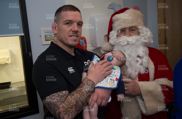 131217 - Ospreys players visit children at Morriston Hospital, Swansea - Osprey Paul James and Father Christmas meet 4 month old Rio Clarke from Port Talbot during their visit to the Children's Ward at Morriston Hospital