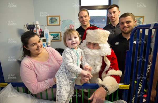 131217 - Ospreys players visit children at Morriston Hospital, Swansea - Ospreys Alun Wyn Jones, Adam Beard and Nicky Smith along with Father Christmas meet 3 year old Cellan Eaton from Ammanford during their visit to the Children's Ward at Morriston Hospital