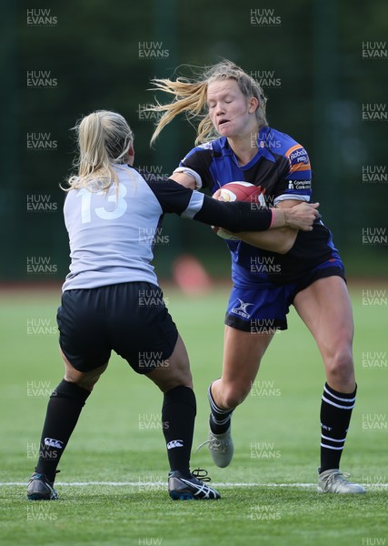 230918 - Ospreys Women v Dragons Women - Carys Cox of Dragons is tackled by Alec Donovan of Ospreys