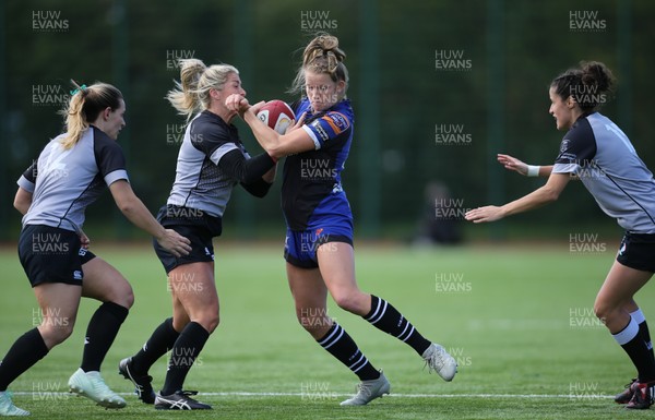 230918 - Ospreys Women v Dragons Women - Carys Cox of Dragons is tackled by Alec Donovan of Ospreys