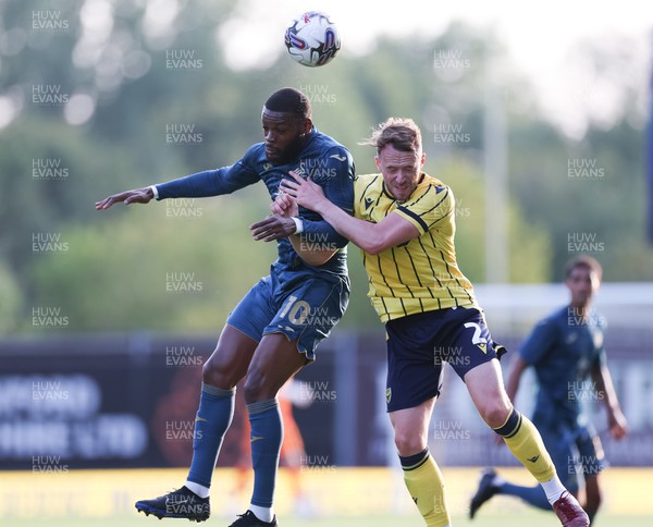 210723 - Oxford United v Swansea City, Pre-season Friendly - Olivier Ntcham of Swansea City and Sam Long of Oxford United compete for the ball