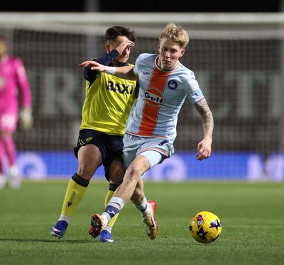 291225 - Oxford United v Swansea City - SkyBet Championship - Melker Widell of Swansea City is tackled by Tyler Goodrham of Oxford United 