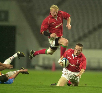 130601 - Pacific Barbarians v Wales -Rhys Williams goes to ground after being ankle tapped by Walter Little (l) as Jamie Ringer comes in to support