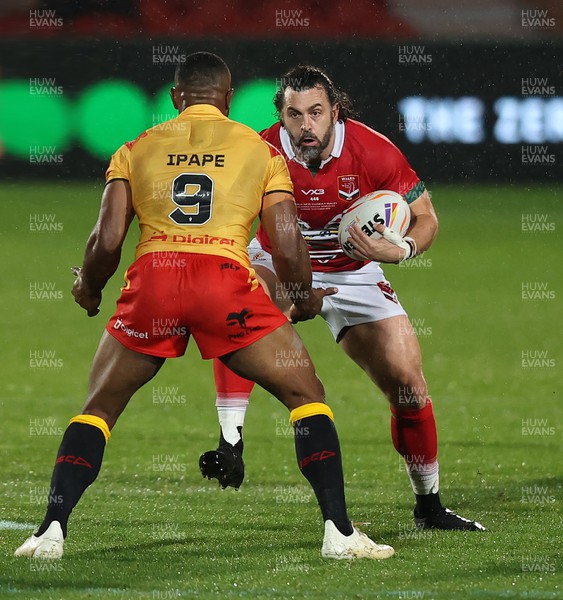 311022 - Papua New Guinea v Wales - Rugby League World Cup 2021 - Rhys Williams of Wales Rugby League is caught by Edwin Ipape of PNG