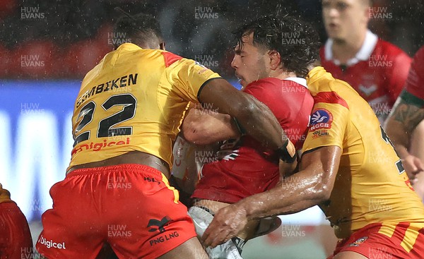 311022 - Papua New Guinea v Wales - Rugby League World Cup 2021 - Bailey Antrobus of Wales Rugby League comes up against Jeremiah Simbiken of PNG and Edwin Ipape of PNG