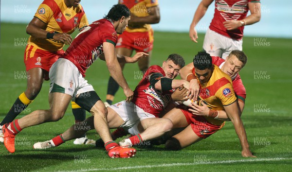 311022 - Papua New Guinea v Wales - Rugby League World Cup 2021 - Connor Davies of Wales Rugby League ad Dan Fleming of Wales Rugby League stop Jacob Alick of PNG from going over the line