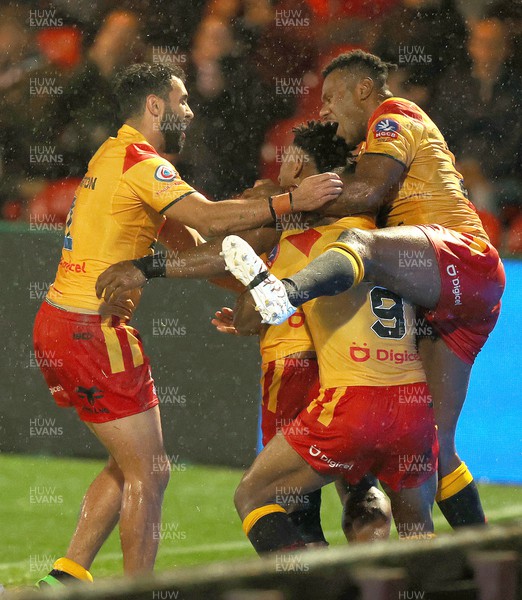 311022 - Papua New Guinea v Wales - Rugby League World Cup 2021 - Jeremiah Simbiken of PNG leaps on scorer Edwin Ipape of PNG back to celebrate his try