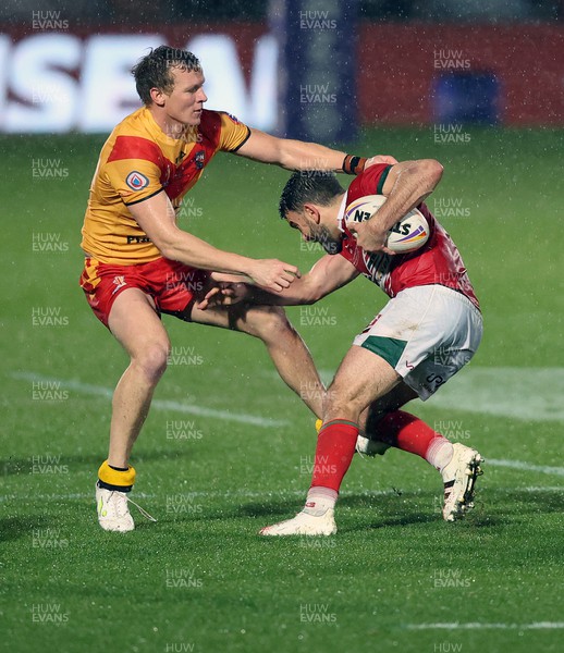 311022 - Papua New Guinea v Wales - Rugby League World Cup 2021 - Elliot Kear of Wales Rugby League tries to find a way through Kyle Laybutt of PNG