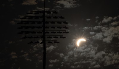 120826 - The partial solar eclipse takes place behind the floodlights of Sophia Gardens Cricket Ground in Cardiff, Wales