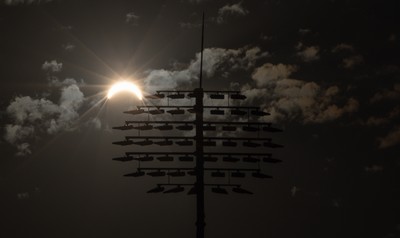 120826 - The partial solar eclipse takes place behind the floodlights of Sophia Gardens Cricket Ground in Cardiff, Wales