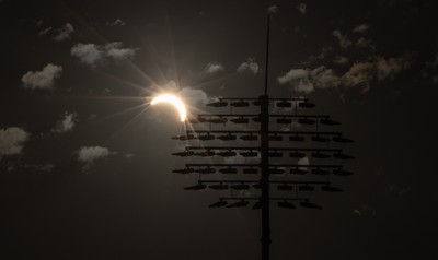 120826 - The partial solar eclipse takes place behind the floodlights of Sophia Gardens Cricket Ground in Cardiff, Wales