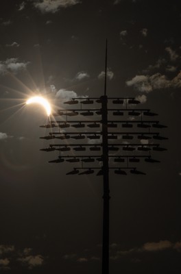 120826 - The partial solar eclipse takes place behind the floodlights of Sophia Gardens Cricket Ground in Cardiff, Wales