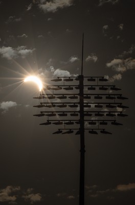 120826 - The partial solar eclipse takes place behind the floodlights of Sophia Gardens Cricket Ground in Cardiff, Wales