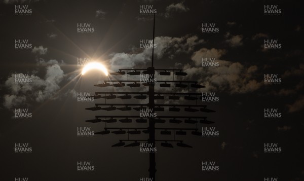 120826 - The partial solar eclipse takes place behind the floodlights of Sophia Gardens Cricket Ground in Cardiff, Wales