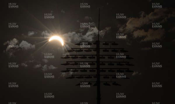 120826 - The partial solar eclipse takes place behind the floodlights of Sophia Gardens Cricket Ground in Cardiff, Wales