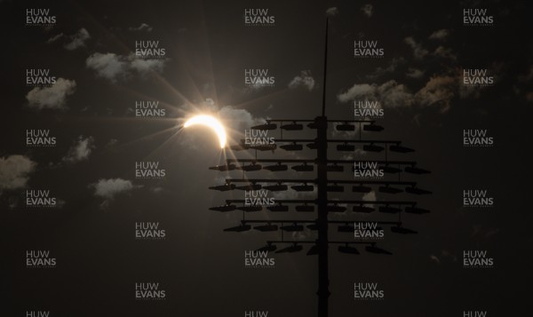 120826 - The partial solar eclipse takes place behind the floodlights of Sophia Gardens Cricket Ground in Cardiff, Wales
