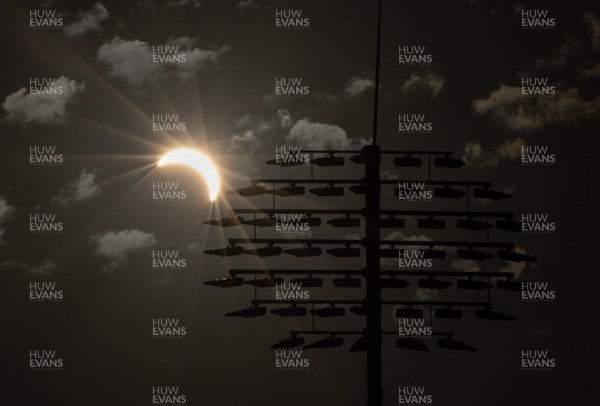 120826 - The partial solar eclipse takes place behind the floodlights of Sophia Gardens Cricket Ground in Cardiff, Wales