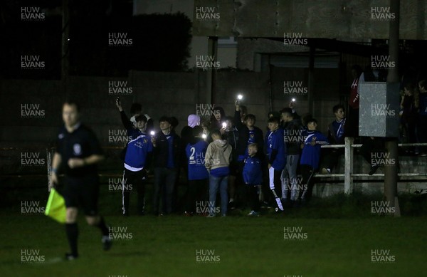 181017 - Caerau v Pontyclun - Welsh Football League Division 3 - As the game is called off due to the flood lights failing the locals shine their phones towards the pitch