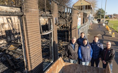 031225 - Penarth RFC Clubhouse Fire - Welsh Rugby Union Community Director Geraint John with Dan Mears, Penarth RFC Secretary and Alan Cozens Penarth RFC Commercial secretary along with Cardiff Rugby and Welsh internationals Mason Grady and Evan Lloyd at the Penarth RFC Clubhouse which was devastated by a recent fire