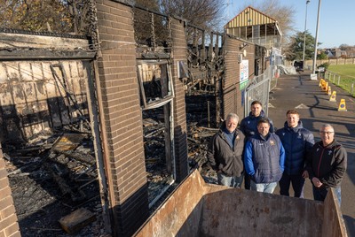 031225 - Penarth RFC Clubhouse Fire - Welsh Rugby Union Community Director Geraint John with Dan Mears, Penarth RFC Secretary and Alan Cozens Penarth RFC Commercial secretary along with Cardiff Rugby and Welsh internationals Mason Grady and Evan Lloyd at the Penarth RFC Clubhouse which was devastated by a recent fire