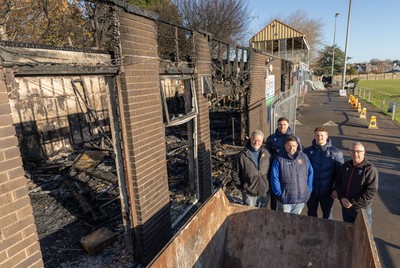 031225 - Penarth RFC Clubhouse Fire - Welsh Rugby Union Community Director Geraint John with Dan Mears, Penarth RFC Secretary and Alan Cozens Penarth RFC Commercial secretary along with Cardiff Rugby and Welsh internationals Mason Grady and Evan Lloyd at the Penarth RFC Clubhouse which was devastated by a recent fire