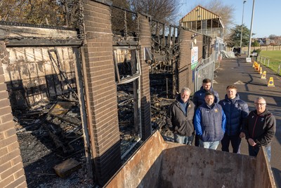 031225 - Penarth RFC Clubhouse Fire - Welsh Rugby Union Community Director Geraint John with Dan Mears, Penarth RFC Secretary and Alan Cozens Penarth RFC Commercial secretary along with Cardiff Rugby and Welsh internationals Mason Grady and Evan Lloyd and Cardiff Rugby Club head coach Corniel van Zyl at the Penarth RFC Clubhouse which was devastated by a recent fire