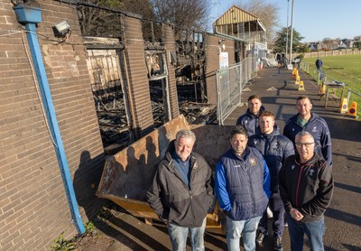 031225 - Penarth RFC Clubhouse Fire - Welsh Rugby Union Community Director Geraint John with Dan Mears, Penarth RFC Secretary and Alan Cozens Penarth RFC Commercial secretary along with Cardiff Rugby and Welsh internationals Mason Grady and Evan Lloyd and Cardiff Rugby Club head coach Corniel van Zyl at the Penarth RFC Clubhouse which was devastated by a recent fire