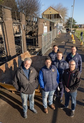031225 - Penarth RFC Clubhouse Fire - Welsh Rugby Union Community Director Geraint John with Dan Mears, Penarth RFC Secretary and Alan Cozens Penarth RFC Commercial secretary along with Cardiff Rugby and Welsh internationals Mason Grady and Evan Lloyd and Cardiff Rugby Club head coach Corniel van Zyl at the Penarth RFC Clubhouse which was devastated by a recent fire