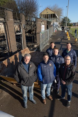 031225 - Penarth RFC Clubhouse Fire - Welsh Rugby Union Community Director Geraint John with Dan Mears, Penarth RFC Secretary and Alan Cozens Penarth RFC Commercial secretary along with Cardiff Rugby and Welsh internationals Mason Grady and Evan Lloyd and Cardiff Rugby Club head coach Corniel van Zyl at the Penarth RFC Clubhouse which was devastated by a recent fire