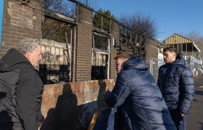 031225 - Penarth RFC Clubhouse Fire - Dan Mears, Penarth RFC Secretary with Cardiff Rugby and Welsh internationals Mason Grady and Evan Lloyd at the Penarth RFC Clubhouse which was devastated by a recent fire